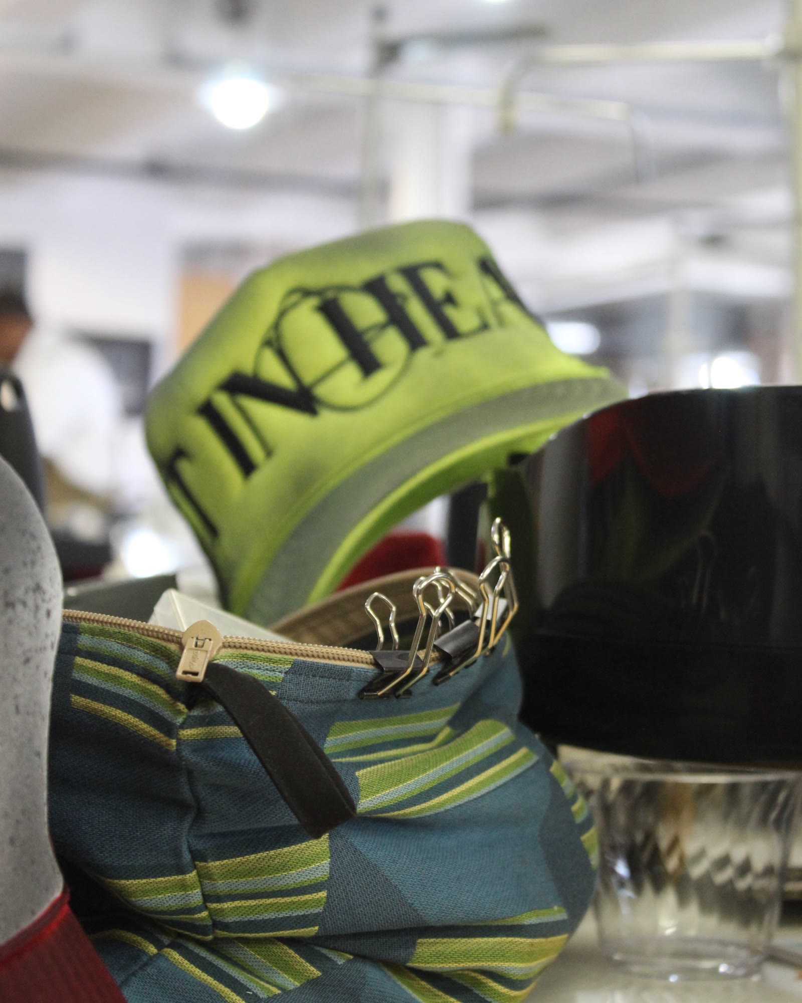 Green IN HEAVEN hat on a woven bag