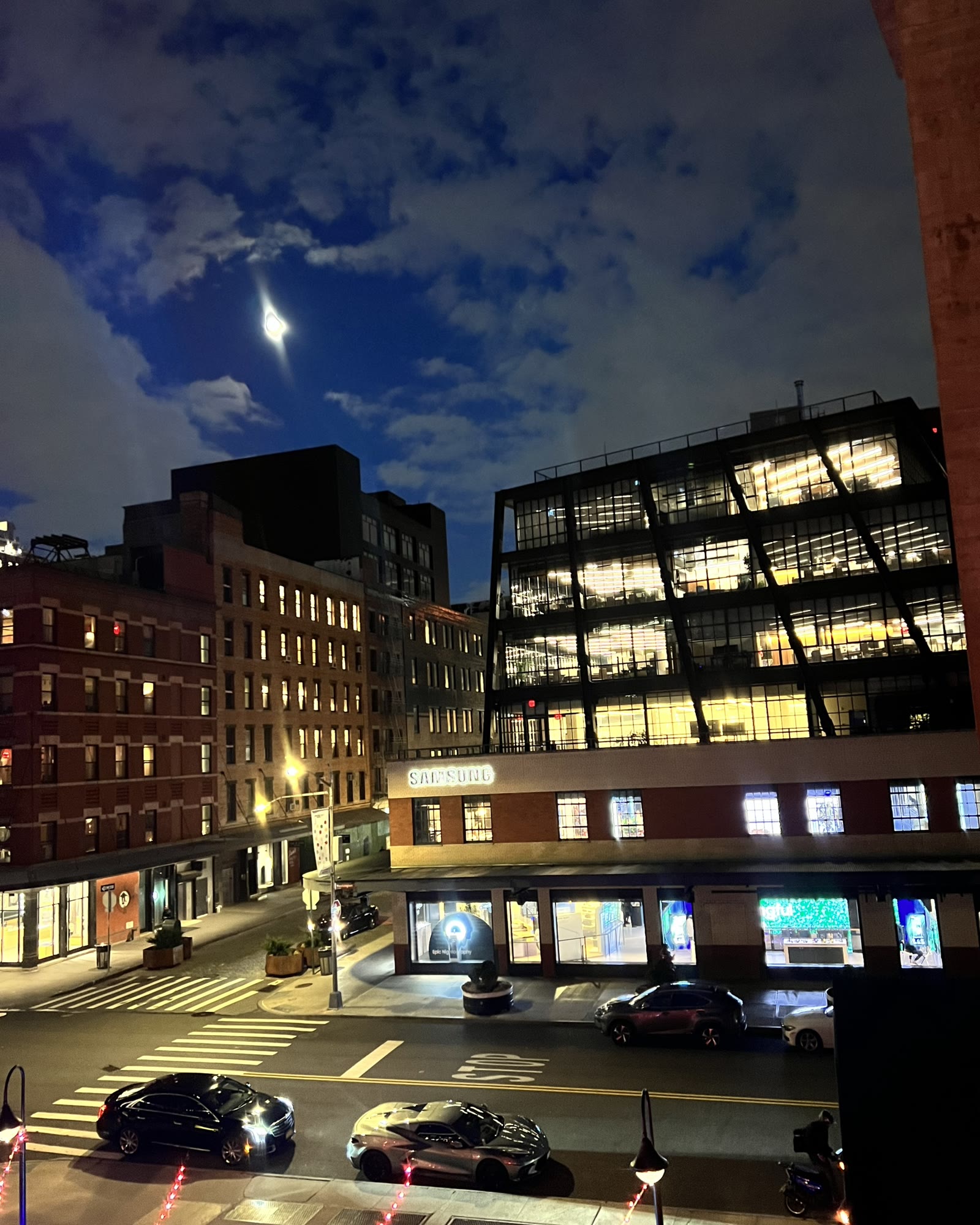Samsung 837 lit up at night under a full moon
